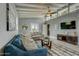 Bright living room with hardwood floors, vaulted ceilings, and comfy seating at 213 Sandy Cir, South Daytona, FL 32119