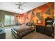 Bright bedroom with colorful accent wall and comfortable bed at 2550 Venetian Way, Winter Park, FL 32789