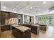 Spacious kitchen boasts dark cabinetry, stainless steel appliances, and an island at 2550 Venetian Way, Winter Park, FL 32789