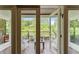 Private balcony overlooking lush trees and water at 2550 Venetian Way, Winter Park, FL 32789