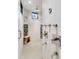 Large walk-in shower with multiple shower heads and a built-in bench at 2550 Venetian Way, Winter Park, FL 32789