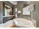 Luxurious bathroom with soaking tub, walk-in shower, and modern fixtures at 2550 Venetian Way, Winter Park, FL 32789
