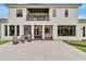 Large backyard patio with seating and outdoor kitchen at 2550 Venetian Way, Winter Park, FL 32789