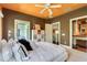 Bedroom with white bedding and access to bathroom at 2550 Venetian Way, Winter Park, FL 32789