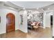 Elegant entryway with a wood door and a dining area with a stylish wallpaper at 2550 Venetian Way, Winter Park, FL 32789