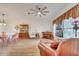 Spacious living area featuring hardwood floors, ample natural light, and a ceiling fan at 5125 Formby Dr, Orlando, FL 32812