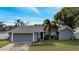 Blue house with a two-car garage and landscaping at 5125 Formby Dr, Orlando, FL 32812