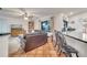 Living room with leather couches, built in shelving and view to kitchen at 5125 Formby Dr, Orlando, FL 32812