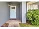 Light blue front door with a charming six-pane window and a small entryway at 5125 Formby Dr, Orlando, FL 32812
