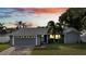 Blue house with a two-car garage and landscaping at dusk at 5125 Formby Dr, Orlando, FL 32812