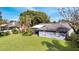 Large backyard with grassy area and view of home at 5125 Formby Dr, Orlando, FL 32812
