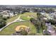 Aerial view of three baseball fields, nearby houses, and lush green trees at 5125 Formby Dr, Orlando, FL 32812