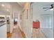 Hallway with terracotta tile floors and access to bedrooms and kitchen at 5125 Formby Dr, Orlando, FL 32812