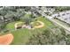 Aerial view of two baseball fields with surrounding trees and parking at 5125 Formby Dr, Orlando, FL 32812