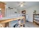 Bright craft room with built-in shelving, a large work table, and a view into another room at 5125 Formby Dr, Orlando, FL 32812