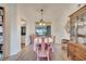 Charming dining room with a rustic wooden hutch and pink chairs at 5125 Formby Dr, Orlando, FL 32812