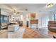 Living room with tile floors, comfortable seating, and a view into the kitchen at 5125 Formby Dr, Orlando, FL 32812