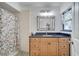 Clean bathroom with floral shower curtain and dark countertop at 5125 Formby Dr, Orlando, FL 32812