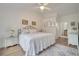Charming bedroom with a white bedspread and en-suite bathroom at 5125 Formby Dr, Orlando, FL 32812