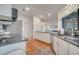 Bright kitchen with white cabinets, granite countertops, and terracotta tile floors at 5125 Formby Dr, Orlando, FL 32812