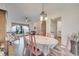 Bright dining area with a large table, pink chairs, and an open concept design at 5125 Formby Dr, Orlando, FL 32812