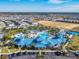 Community pool and clubhouse with surrounding homes at 617 Jasmine Ln, Davenport, FL 33897
