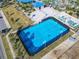 Aerial view of a community basketball court with blue surface and surrounding fence at 617 Jasmine Ln, Davenport, FL 33897