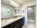 Double vanity bathroom with granite countertop and shower at 617 Jasmine Ln, Davenport, FL 33897