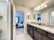 Double vanity bathroom with granite countertop and a shower at 617 Jasmine Ln, Davenport, FL 33897