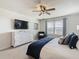 Spacious bedroom with large bed, dresser, and ceiling fan at 617 Jasmine Ln, Davenport, FL 33897