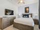 Bedroom with a queen bed, dresser, and TV at 617 Jasmine Ln, Davenport, FL 33897