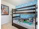 bedroom with bunk beds and Toy Story theme at 617 Jasmine Ln, Davenport, FL 33897