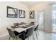 Elegant dining area with marble table and six chairs at 617 Jasmine Ln, Davenport, FL 33897