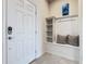 Inviting entryway with built-in bench, shelving, and coat hooks at 617 Jasmine Ln, Davenport, FL 33897