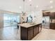 Open kitchen features an island and a view of the pool at 617 Jasmine Ln, Davenport, FL 33897