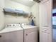 Convenient laundry room with washer, dryer, and shelving at 617 Jasmine Ln, Davenport, FL 33897