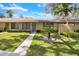 Tan house exterior with green door, landscaping, and walkway at 725 Northlake Blvd # 45, Altamonte Springs, FL 32701