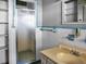 Bathroom with shower, sink, and built-in shelving at 9745 Ne 306Th Ct, Fort Mc Coy, FL 32134
