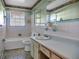 Bathroom with bathtub, toilet and vanity with striped countertop at 9745 Ne 306Th Ct, Fort Mc Coy, FL 32134