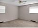 Simple carpeted bedroom with ceiling fan and neutral walls at 9745 Ne 306Th Ct, Fort Mc Coy, FL 32134