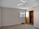 Carpeted bedroom with ceiling fan, window, and closet at 9745 Ne 306Th Ct, Fort Mc Coy, FL 32134