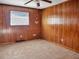 Simple bedroom with wood paneled walls and carpeting at 9745 Ne 306Th Ct, Fort Mc Coy, FL 32134