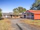 Gravel driveway leading to a house with attached garage and separate carport at 9745 Ne 306Th Ct, Fort Mc Coy, FL 32134