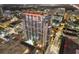 Night aerial view of a modern highrise building with a pool at 155 S Court Ave # 2609, Orlando, FL 32801