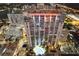Nighttime aerial of highrise building, pool, and city lights at 155 S Court Ave # 2609, Orlando, FL 32801