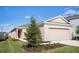 Tan one-story house with a two-car garage and landscaping at 188 Brinsmead Rd, Haines City, FL 33844