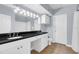 Bathroom with double vanity, black countertop and tile floors at 204 E South St # 1055, Orlando, FL 32801