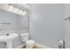 Clean bathroom with pedestal sink, toilet and mirror at 204 E South St # 1055, Orlando, FL 32801