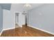 Well-lit bedroom featuring hardwood floors and access to bathroom at 204 E South St # 1055, Orlando, FL 32801