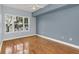 Comfortable bedroom with hardwood floors and a large window at 204 E South St # 1055, Orlando, FL 32801